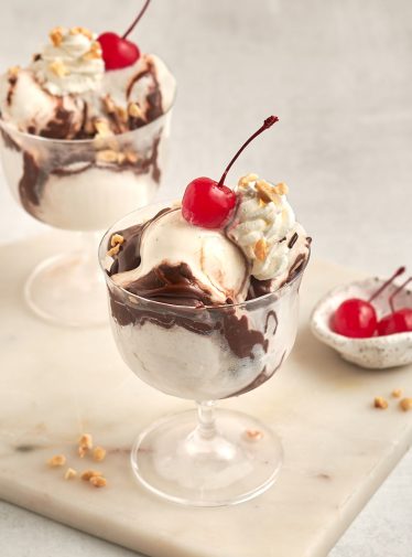 hot fudge sundaes with bowl of cherries