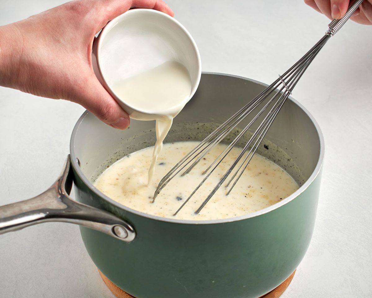 milk/cornstarch mixture added to saucepan containing  milk, the heavy cream, sugar, corn syrup, salt, and vanilla bean and seeds