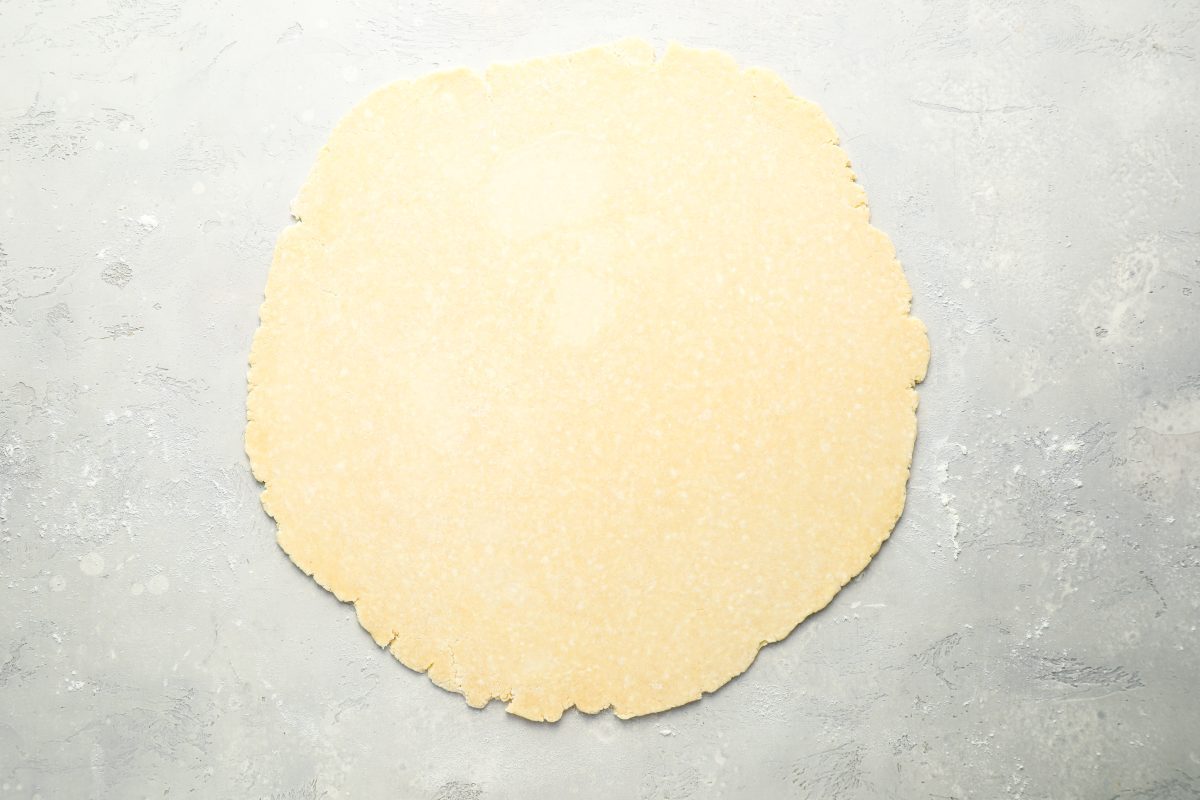 larger dough ball rolled into 13-inch circle