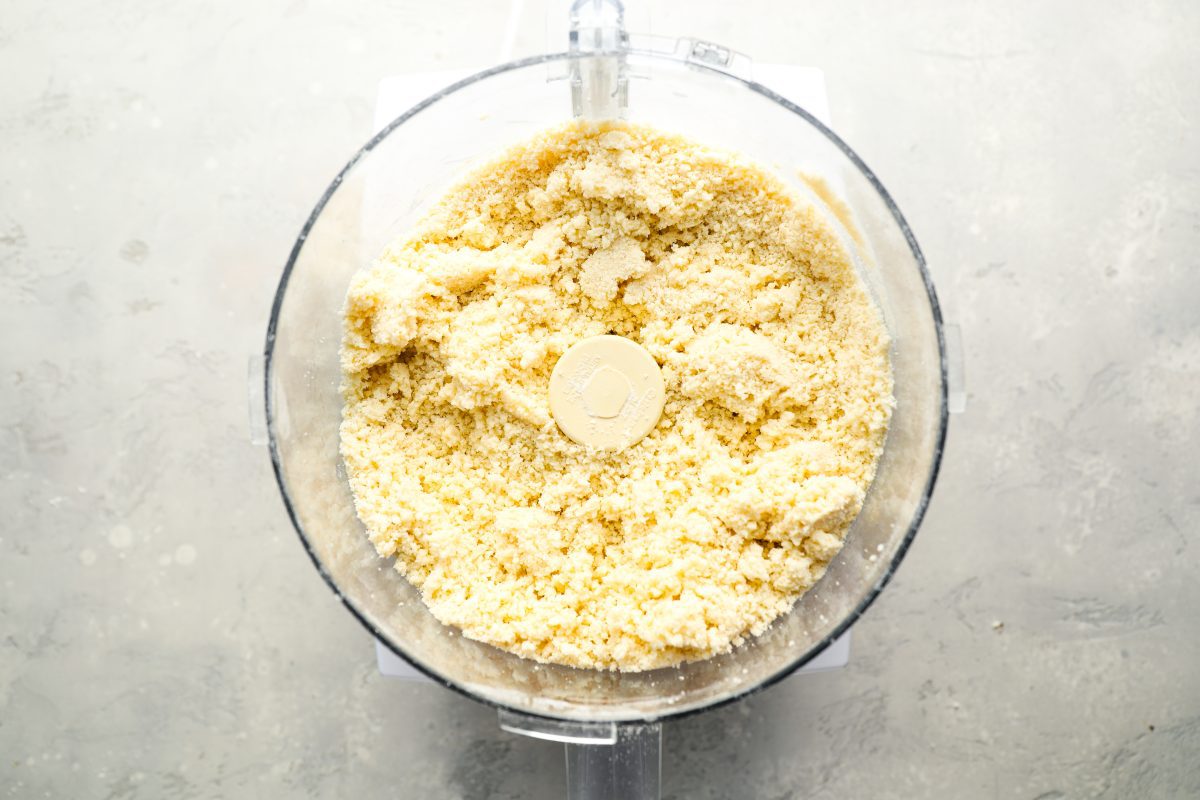 water combined with flour, sugar, salt, butter and baking powder in bowl of food processor 