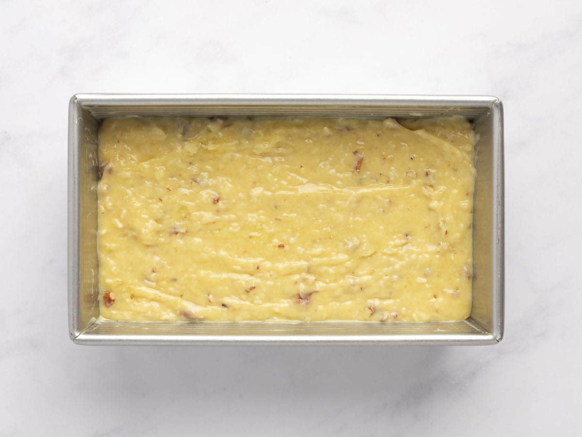 banana bread batter poured into metal 9 x 5-inch loaf pan