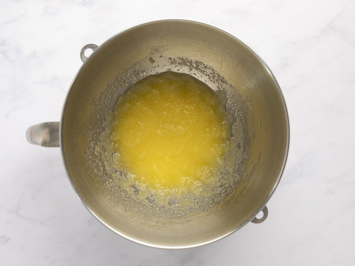 melted butter and sugar mixed together in metal mixing bowl
