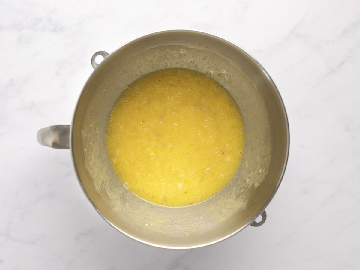 melted butter, sugar, eggs, bananas, and vanilla combined in metal mixing bowl