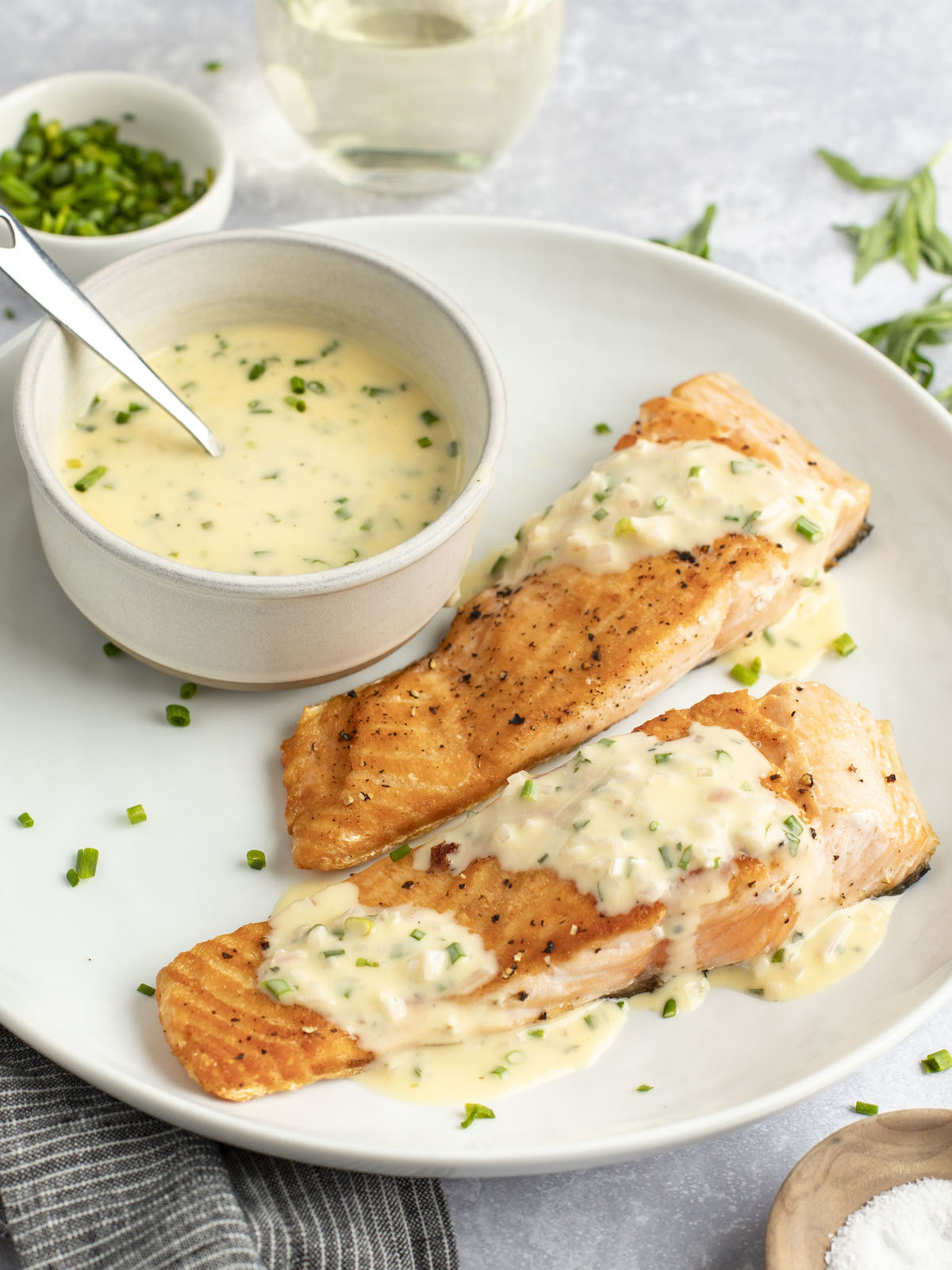 beurre blanc being spooned over salmon