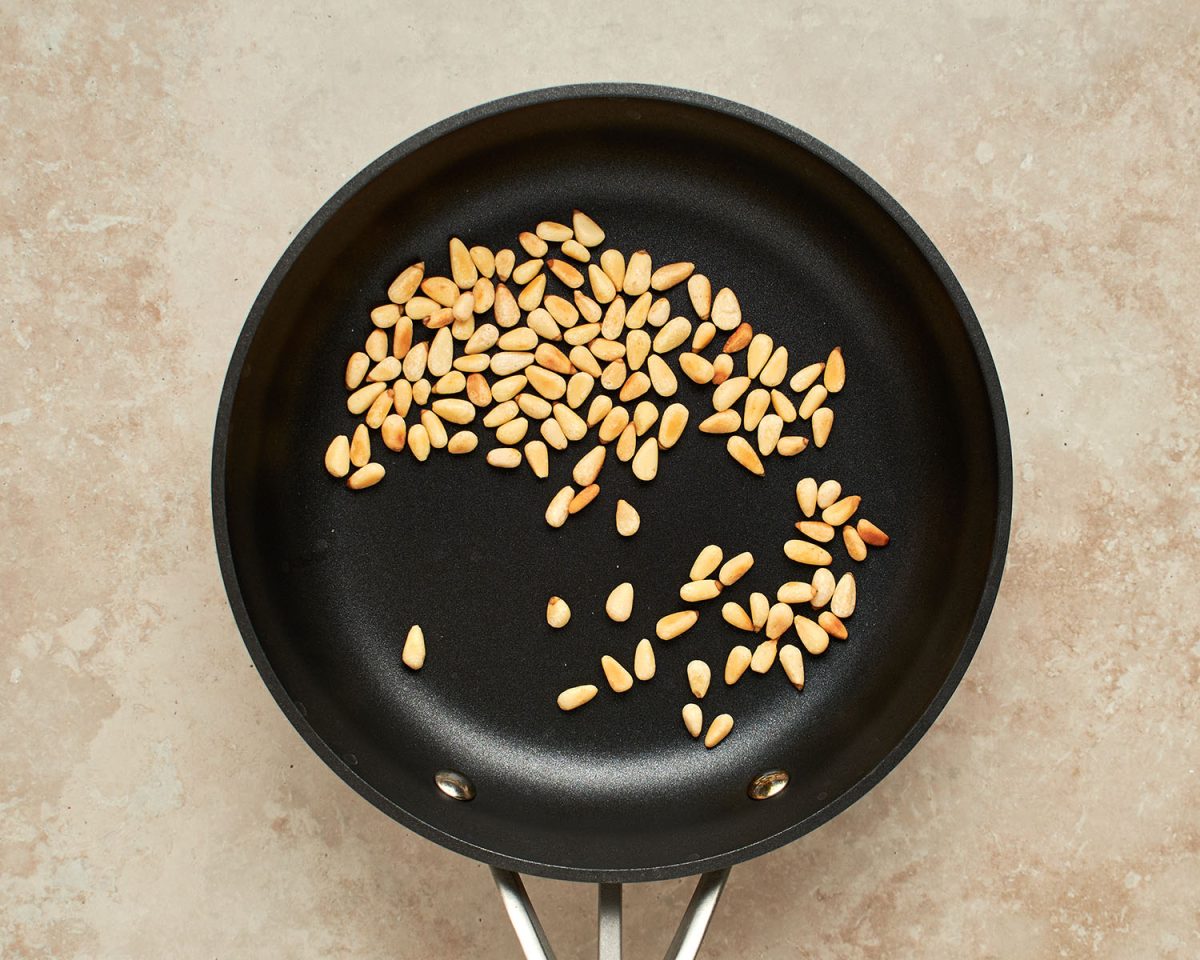 golden brown pine nuts in small skillet