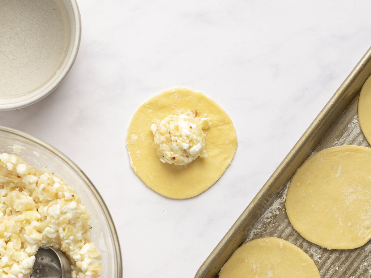 tablespoon of filling in center of one dough disk