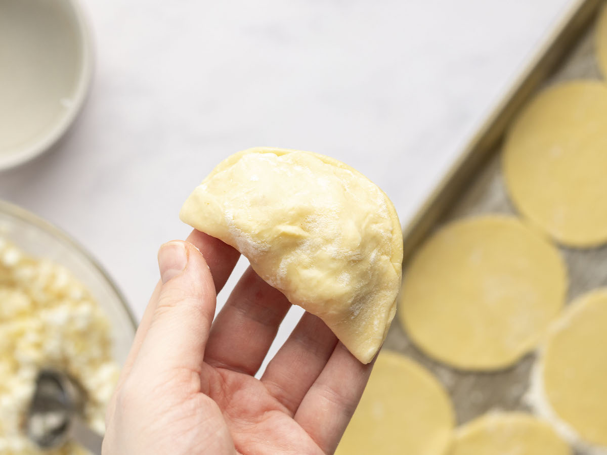 pierogi dough folded in half over filling