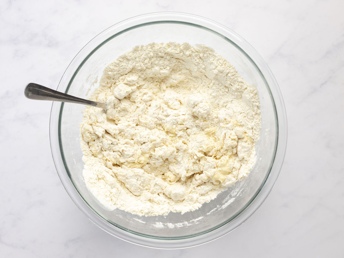 stirring flour mixture and water/egg mixture with a fork