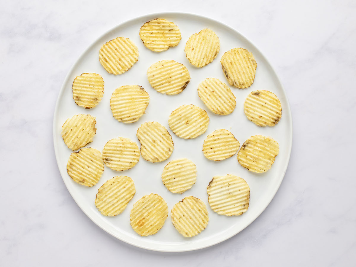 potato chips arranged on white serving platter