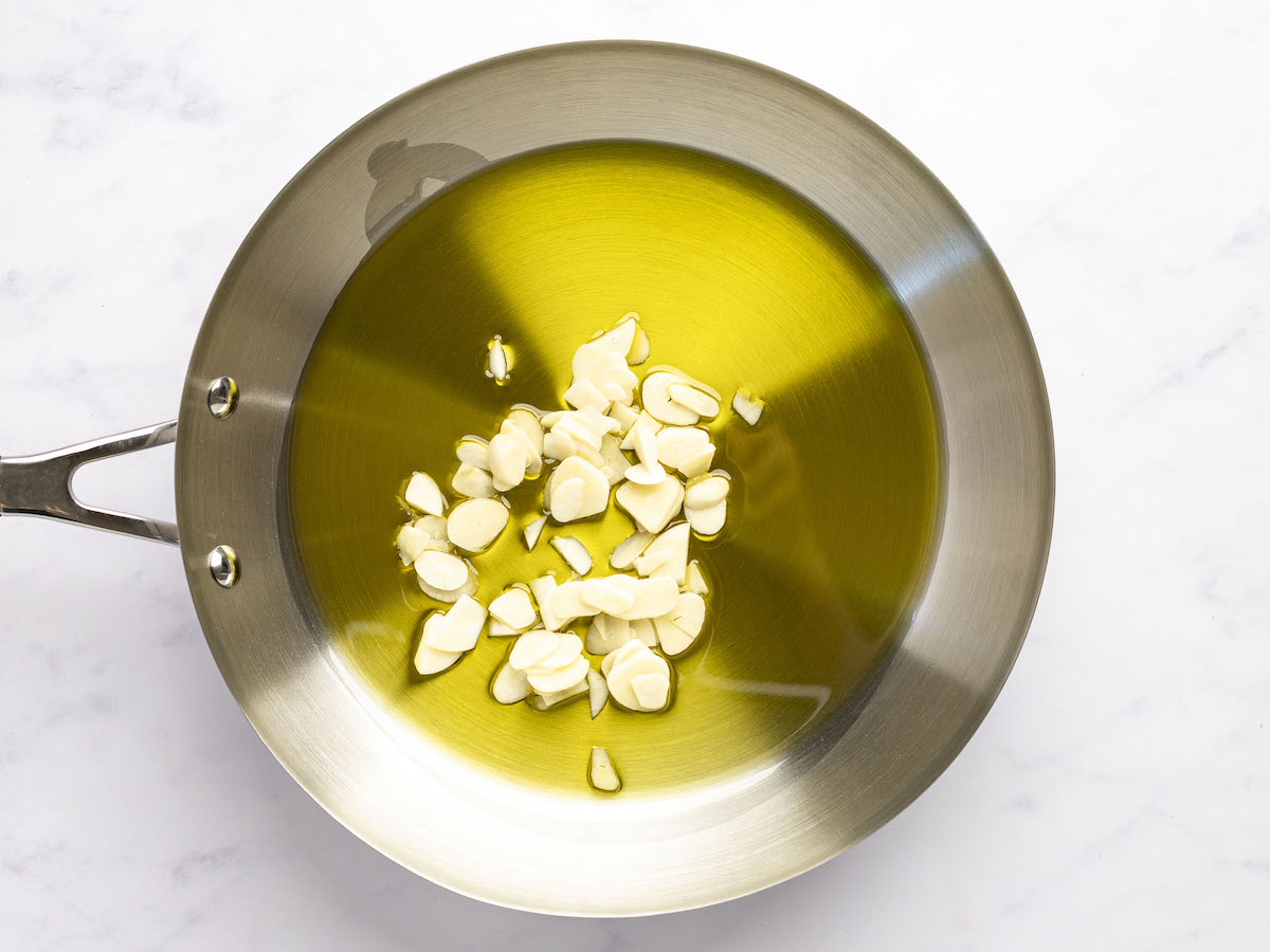 sliced garlic and olive oil in large skillet