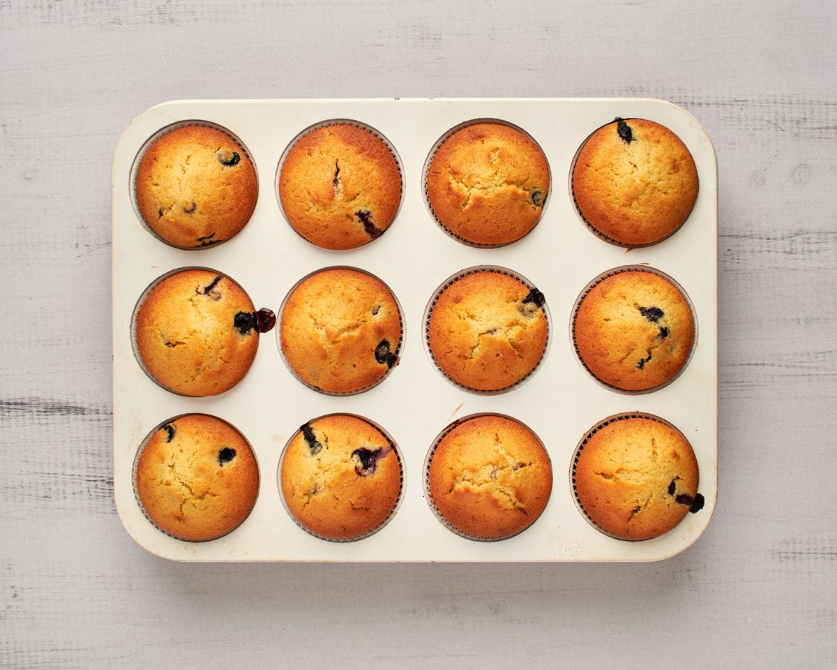 baked blueberry cornbread muffins in muffin pan