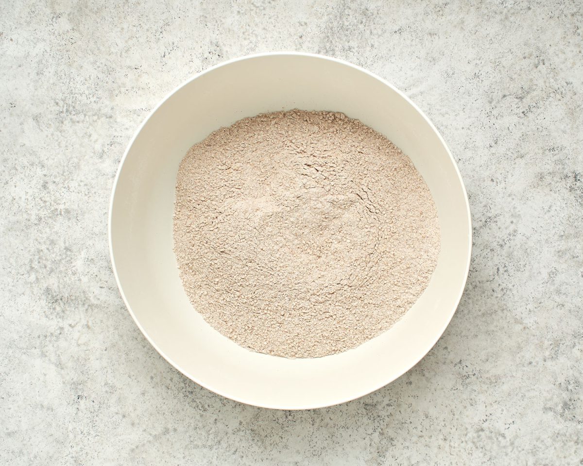 all-purpose flour, the wheat flour, wheat bran (or wheat germ), baking powder, baking soda, salt, and cinnamon combined in large white bowl