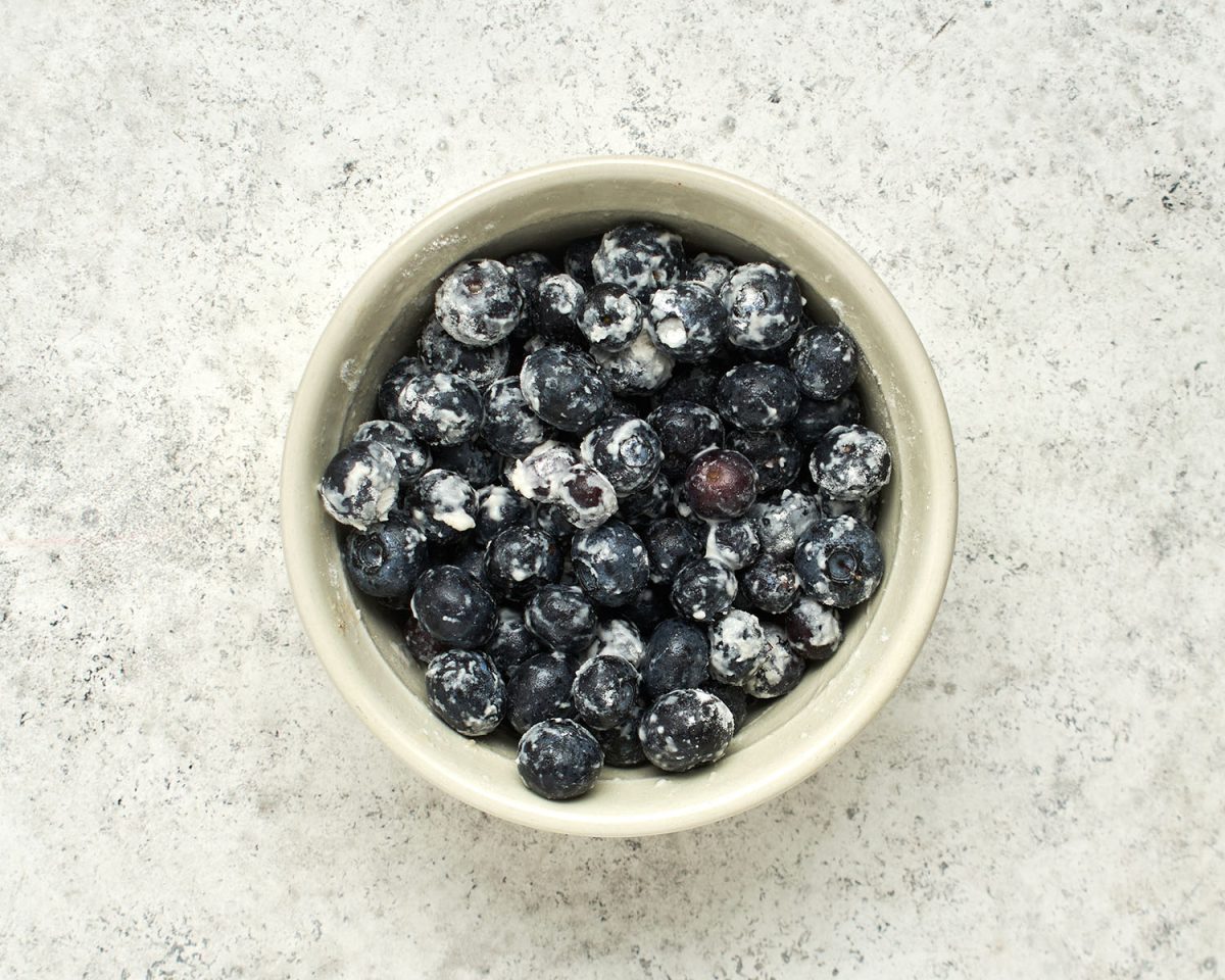 small bowl with flour-coated blueberries