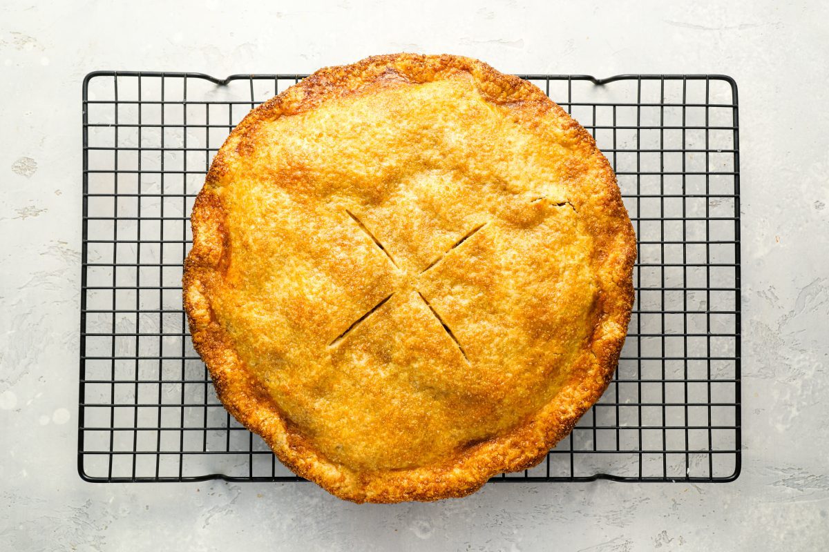 baked apple pie cooling on wire rack