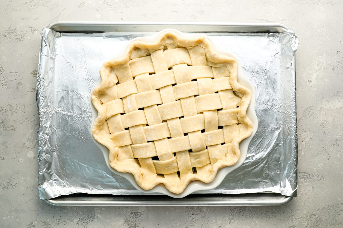 unbaked blueberry pie on foil-lined baking sheet