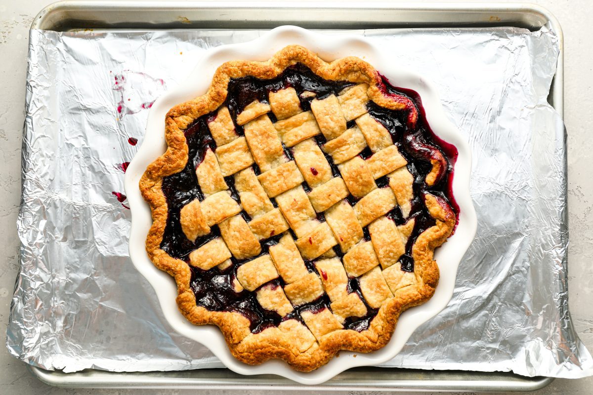 baked blueberry pie on foil-lined baking sheet