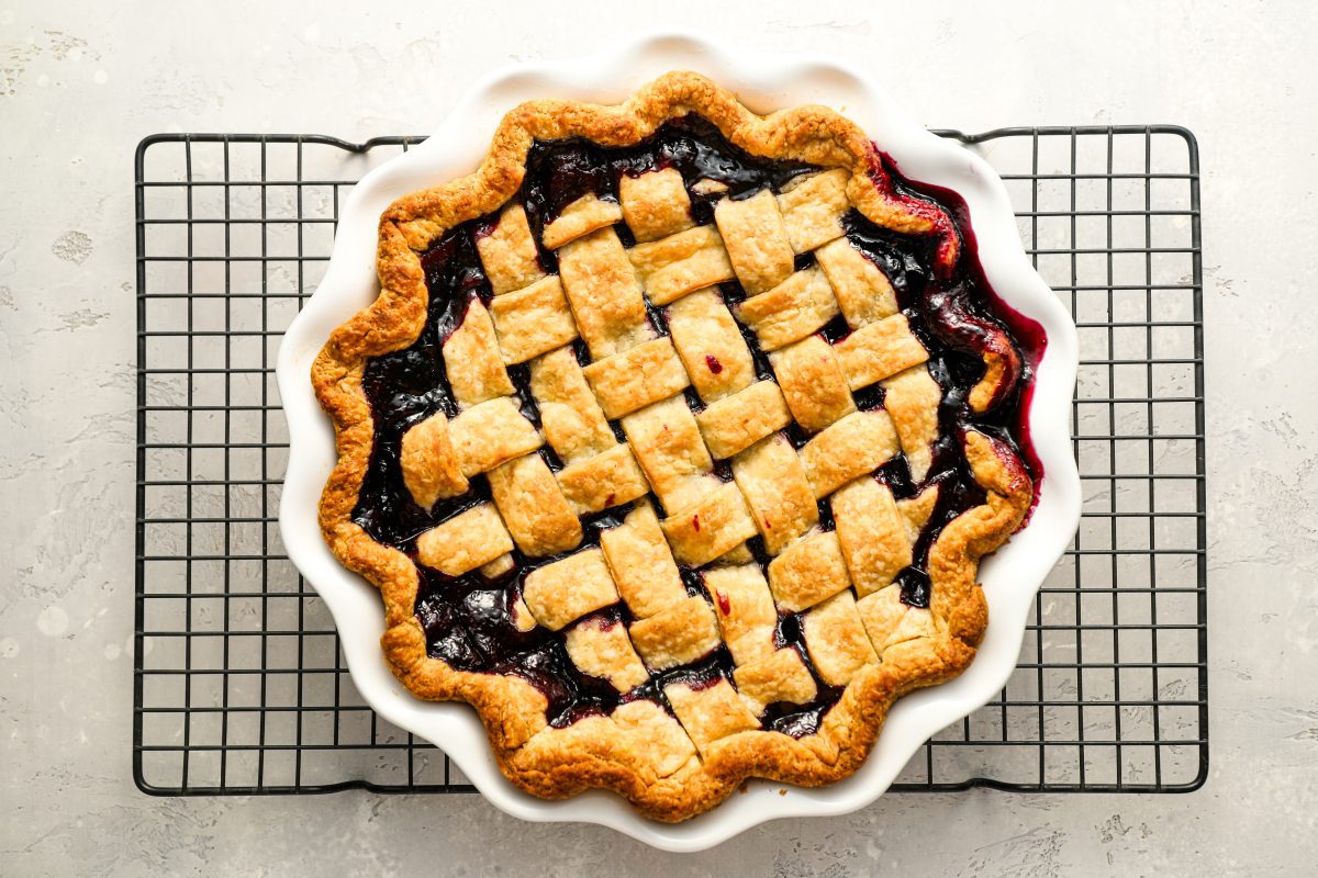 baked blueberry pie on metal cooling rack