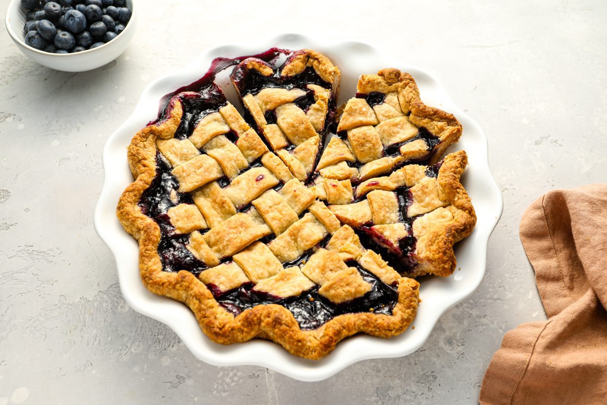 blueberry pie with bowl of blueberries