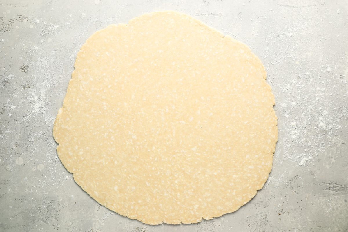 dough disk rolled into 13-inch circle