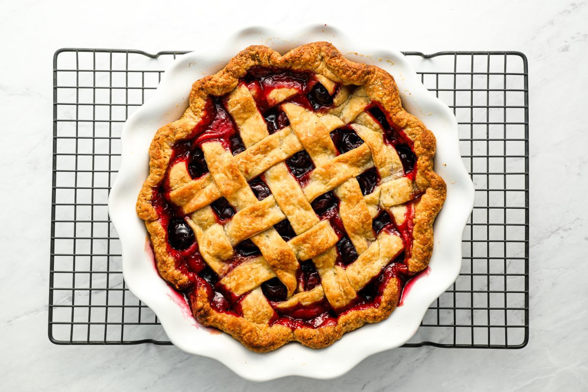 baked cherry pie on metal cooking rack