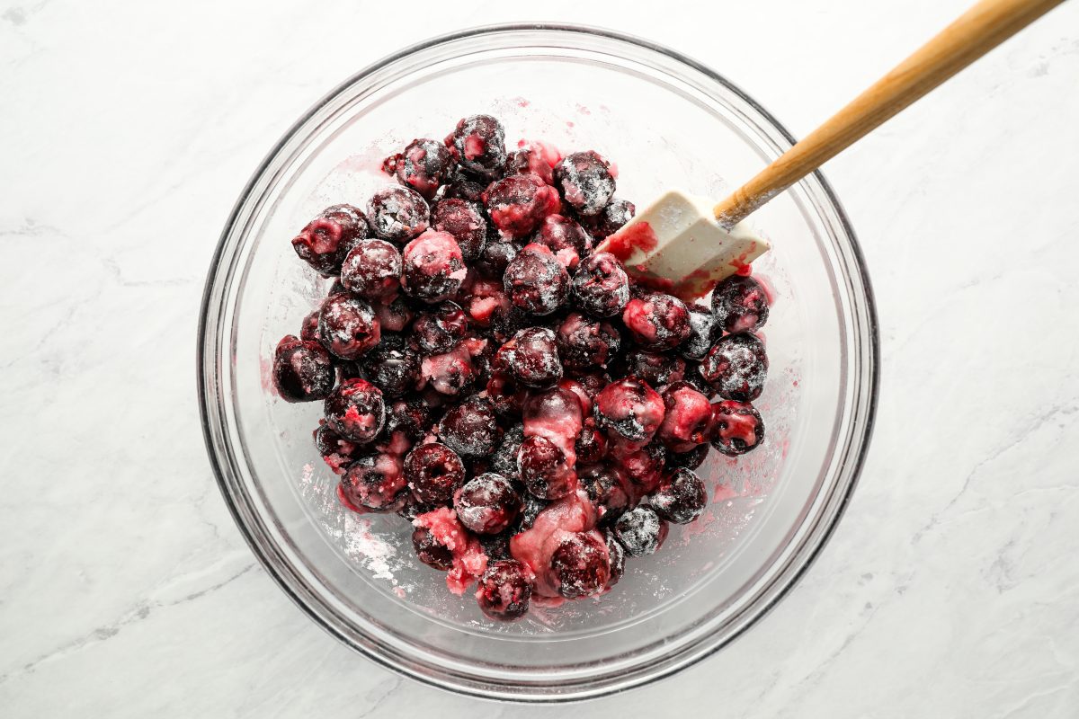 large glass bowl with cherries, lemon juice, almond extract, sugar, salt, and tapioca flour combined together