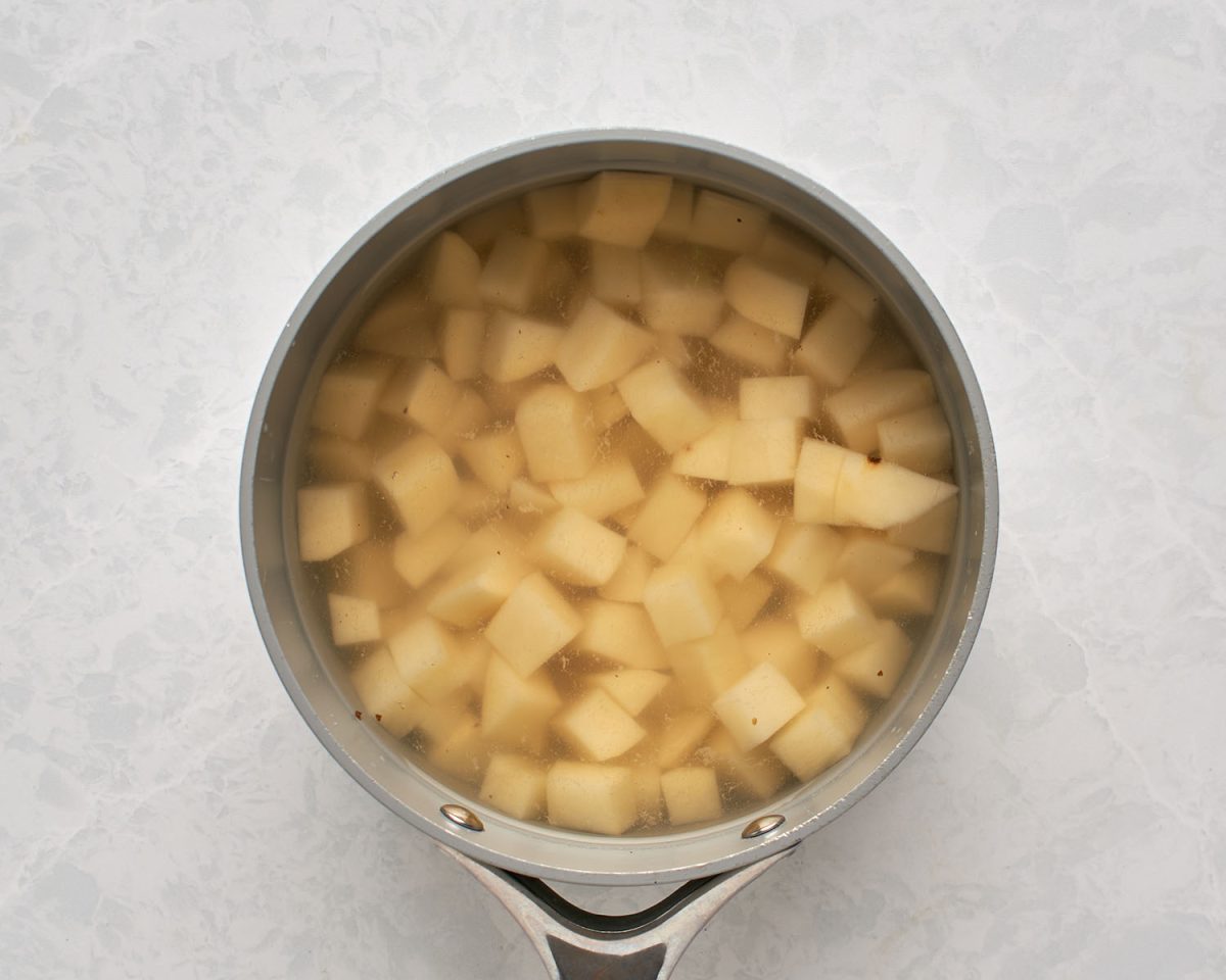 large pot with diced potatoes in in water