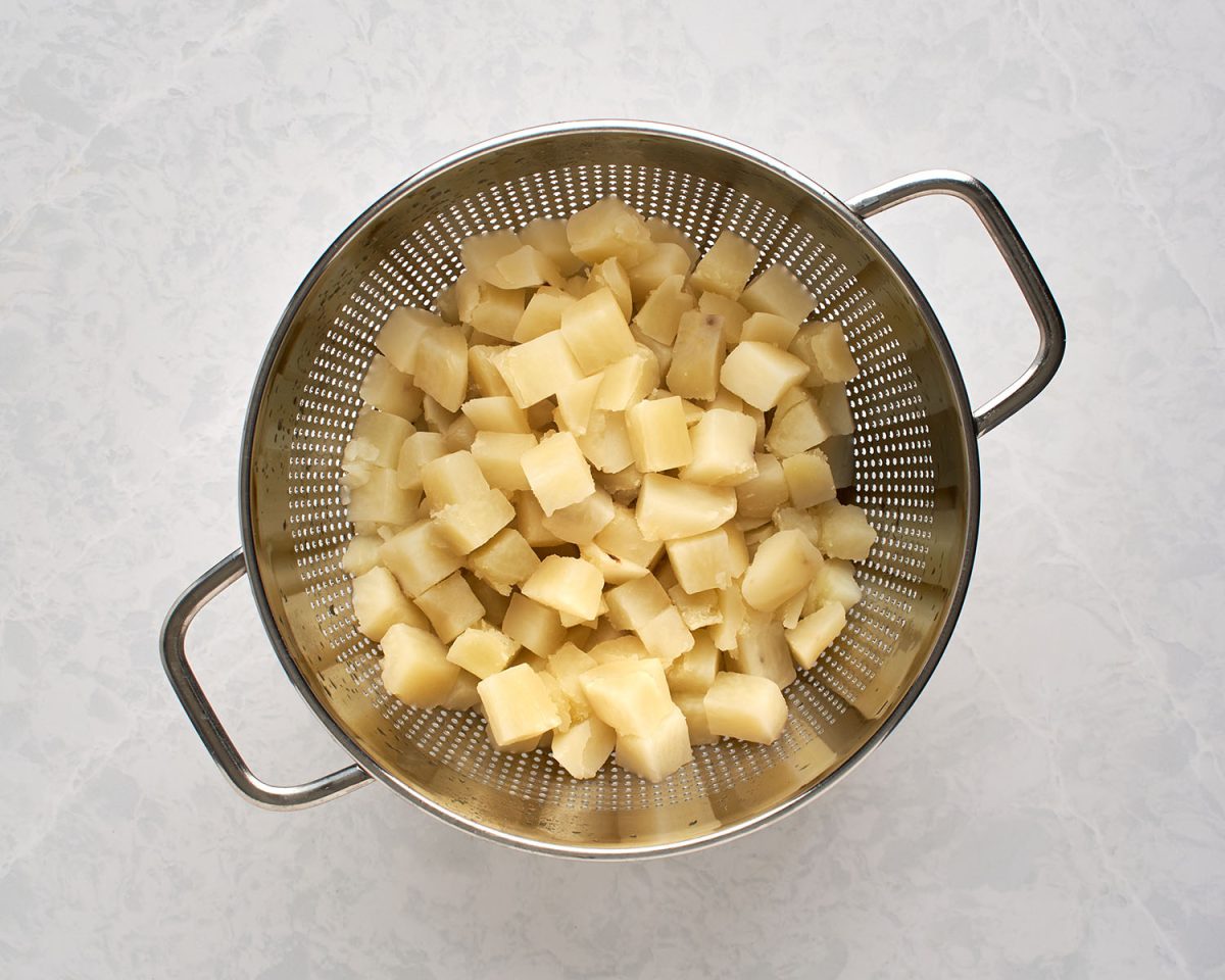 cooked potatoes in colander