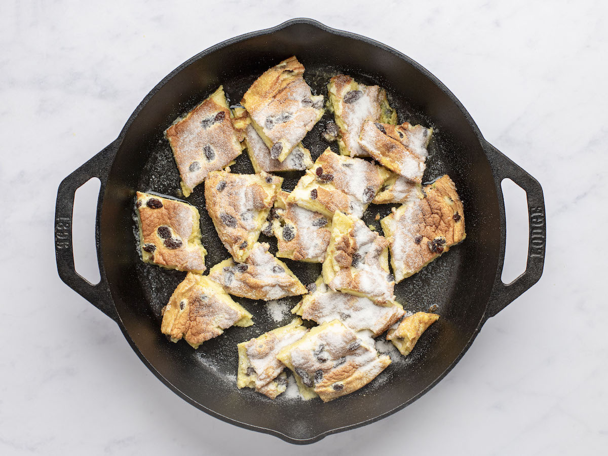 kaiserschmarrn pieces coated with granulated sugar in large non-stick skillet