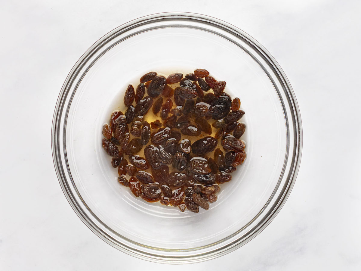 raisins and rum in glass bowl