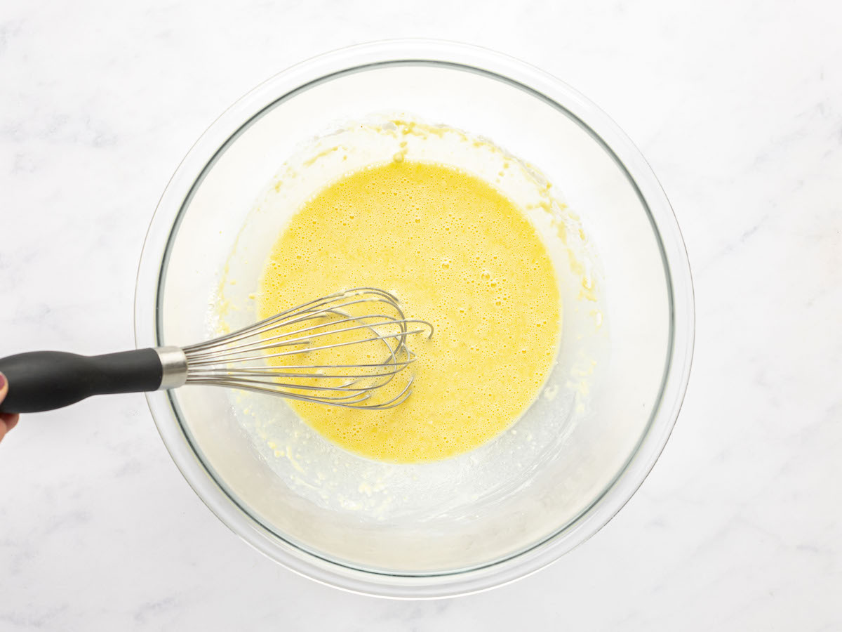 the egg yolks, milk, vanilla, and 1 tablespoon rum whisked together in large bowl 