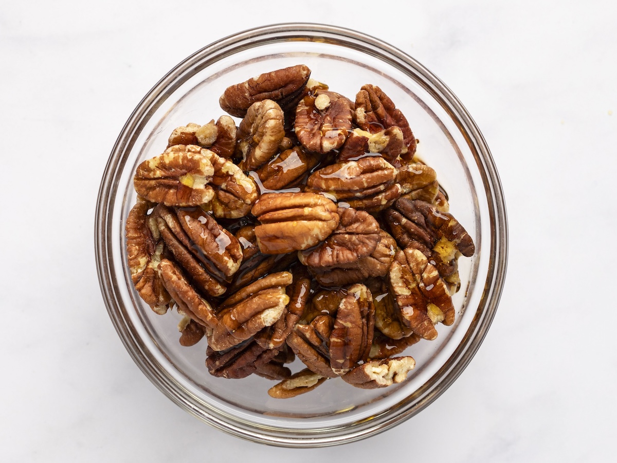 pecans and maple syrup in bowl