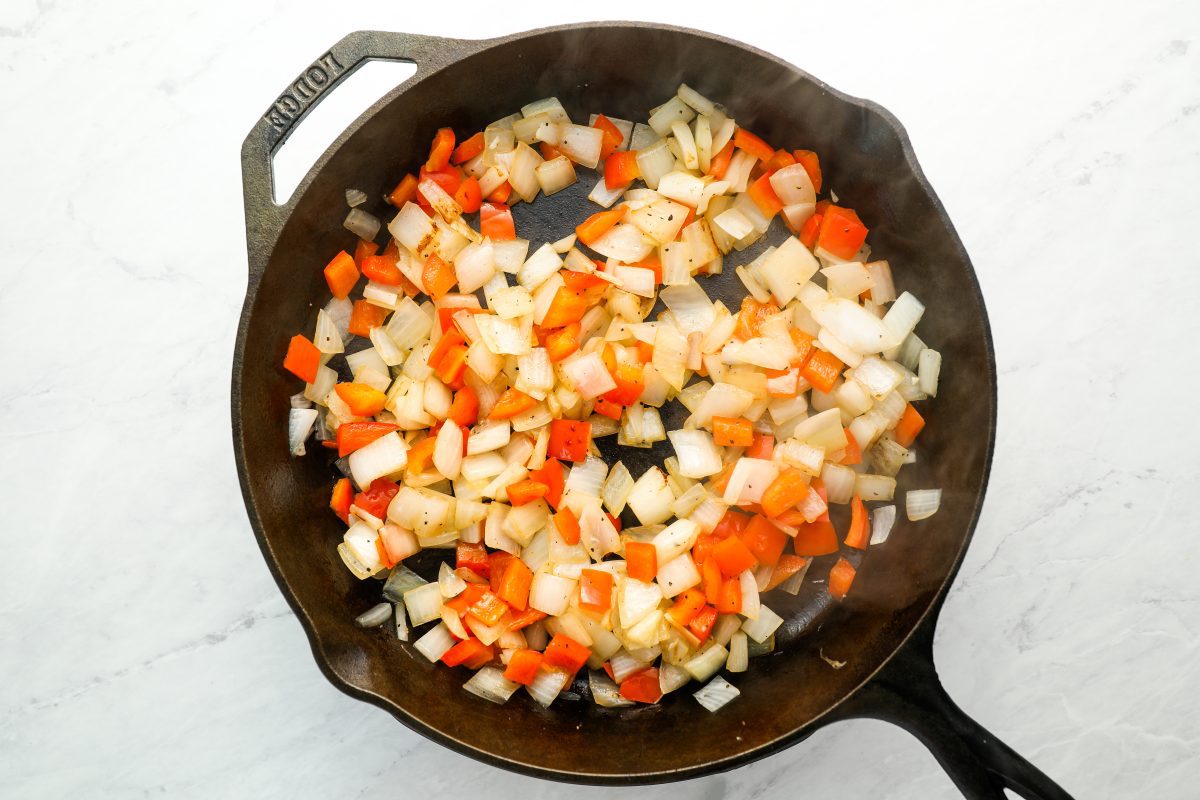 diced onions, peppers, salt, and pepper in large cast iron pan