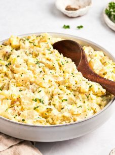 bowl of potato salad with wooden spoon