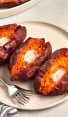 baked sweet potatoes with butter on platter with dish towel