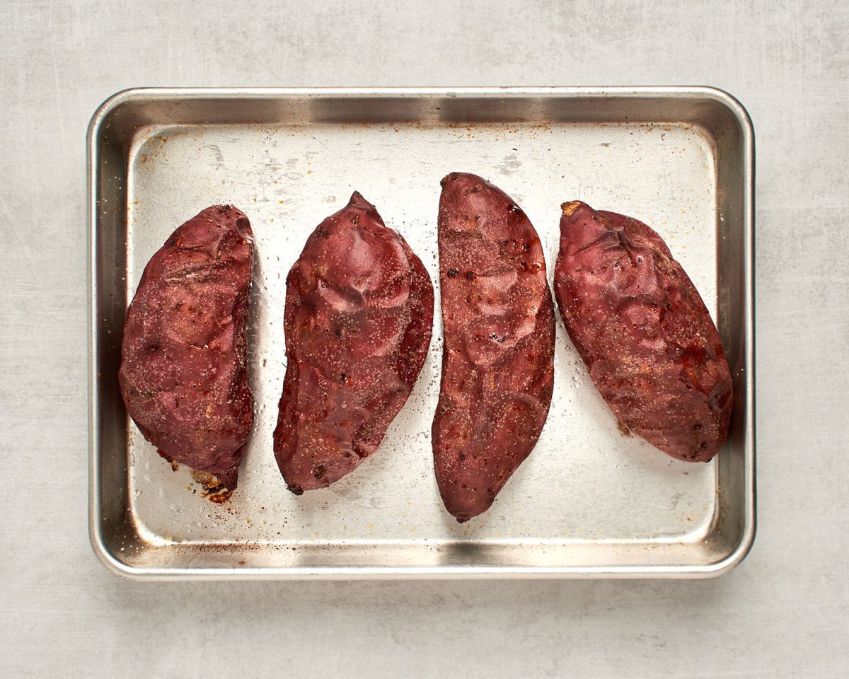 baked sweet potatoes on baking sheet