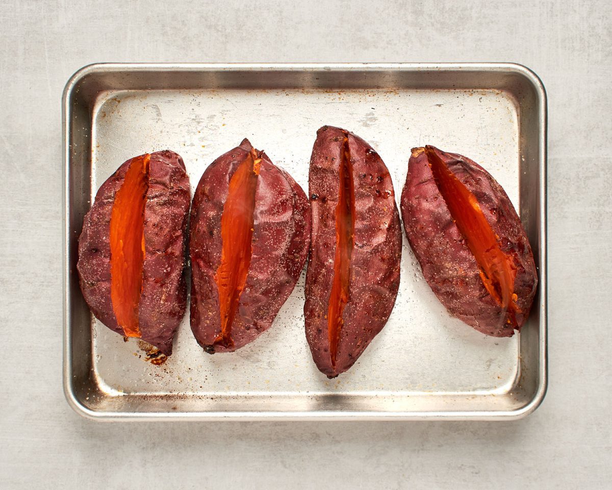 slit baked sweet potatoes on baking sheet