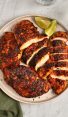 blackened chicken sliced on platter with green napkin