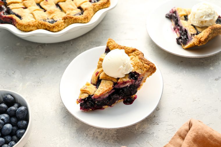 slice of blueberry pie with vanilla ice cream