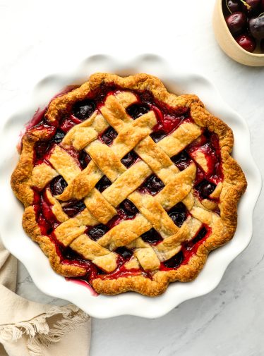 cherry pie with a bowl of cherries