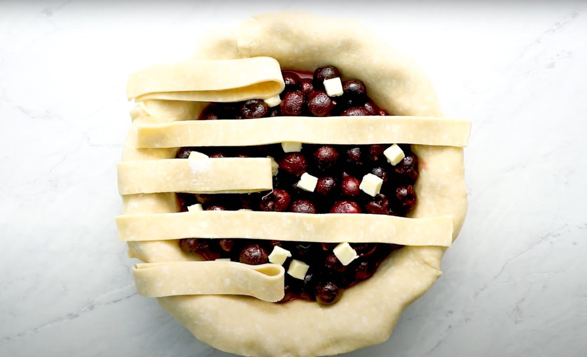 process of creating lattice crust for cherry pie