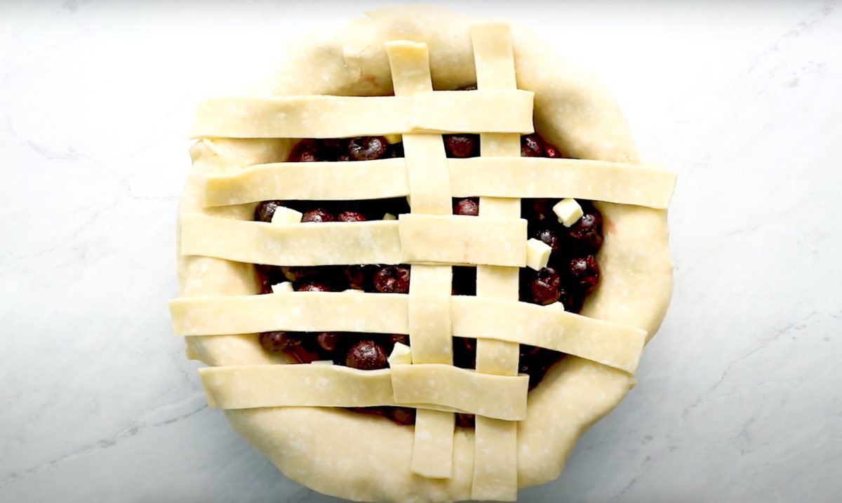 process of creating lattice crust for cherry pie