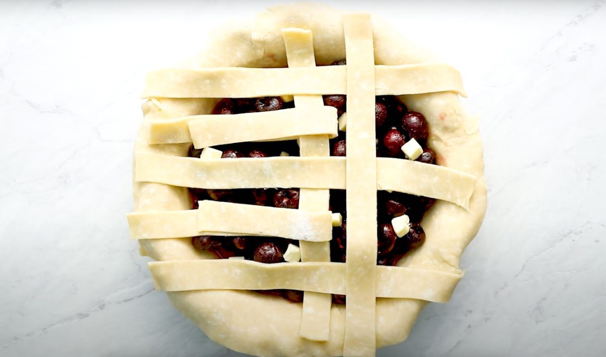 process of creating lattice crust for cherry pie