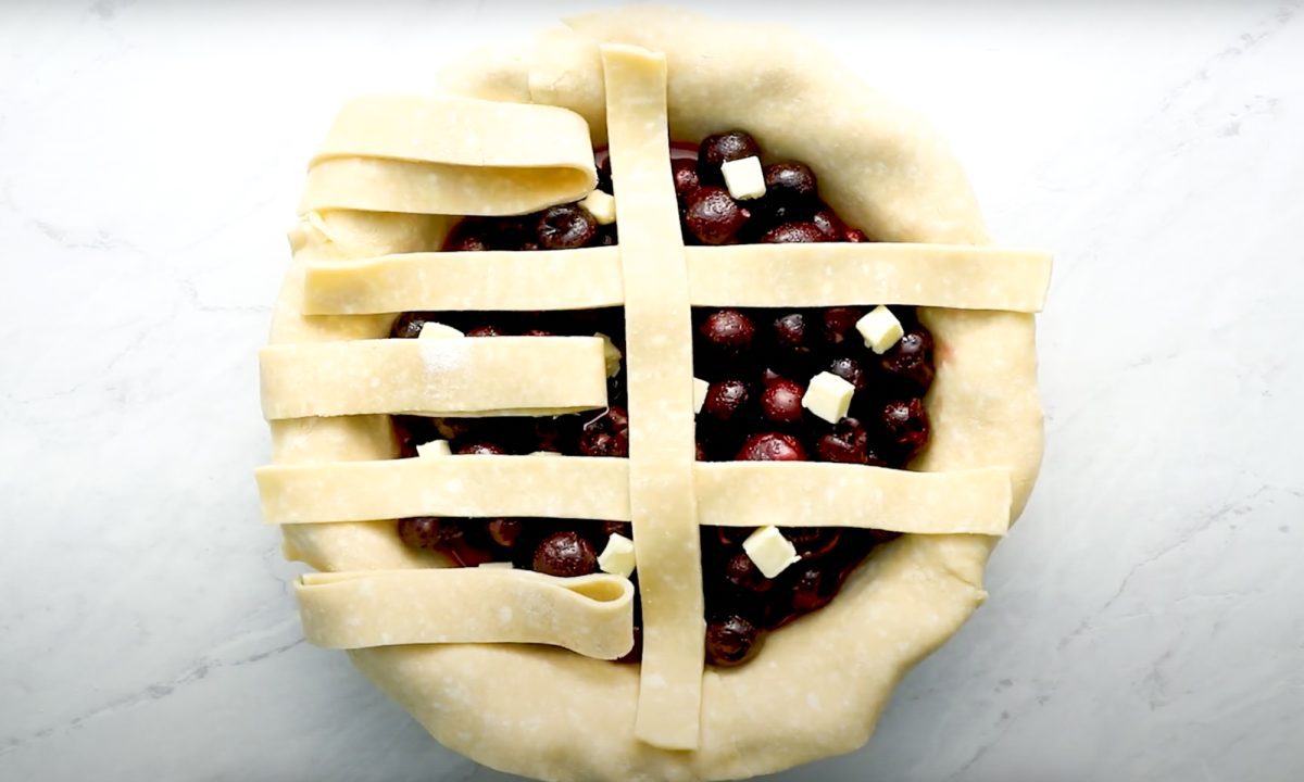 process of creating lattice crust for cherry pie