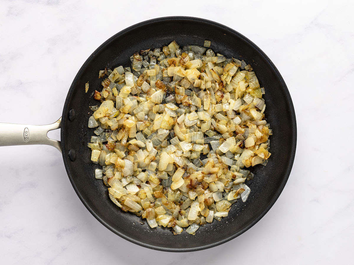 large skillet with cooked onion mixture