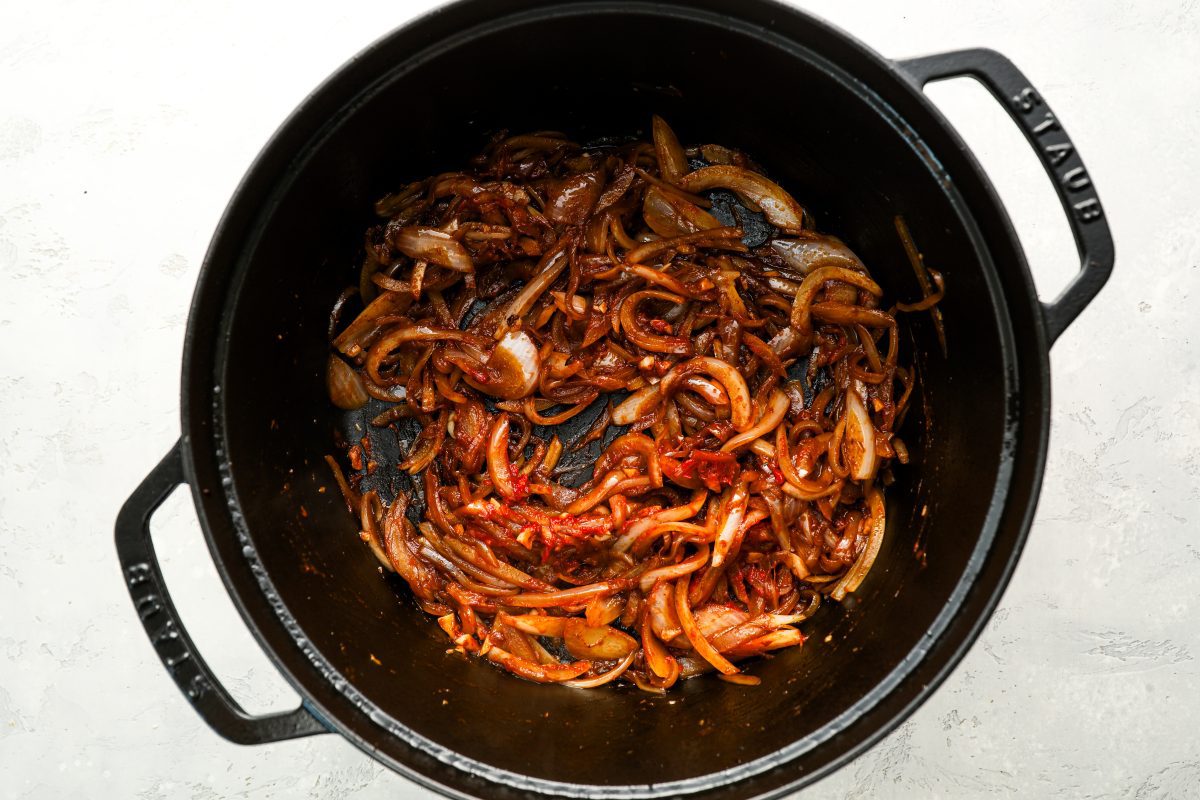 dutch oven with browned onions, garlic, balsamic vinegar, and tomato paste