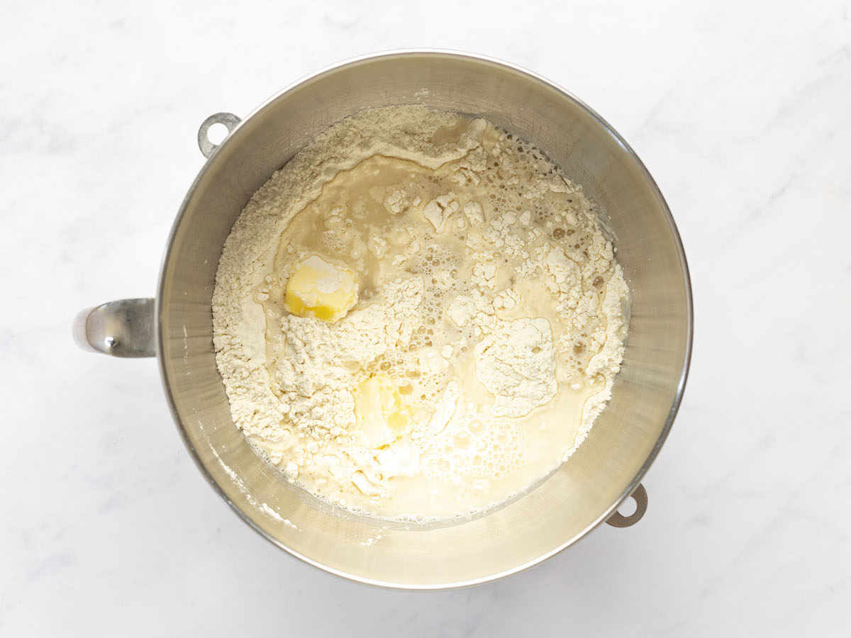 water and butter added to bowl with yeast, sugar, and salt