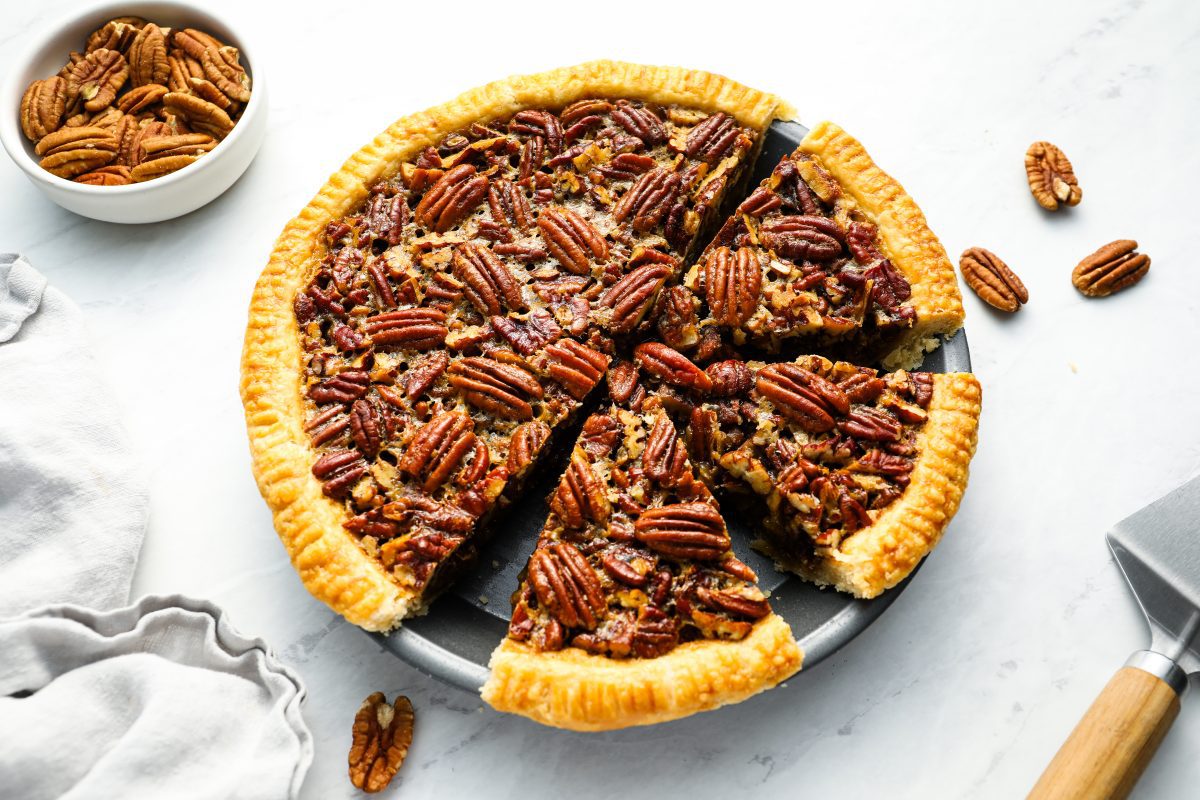 baked pecan pie with 3 slices cut