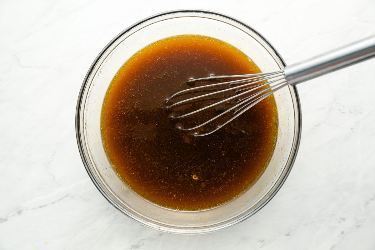 large bowl with melted butter, sugar, corn syrup, eggs, bourbon, vanilla, and salt