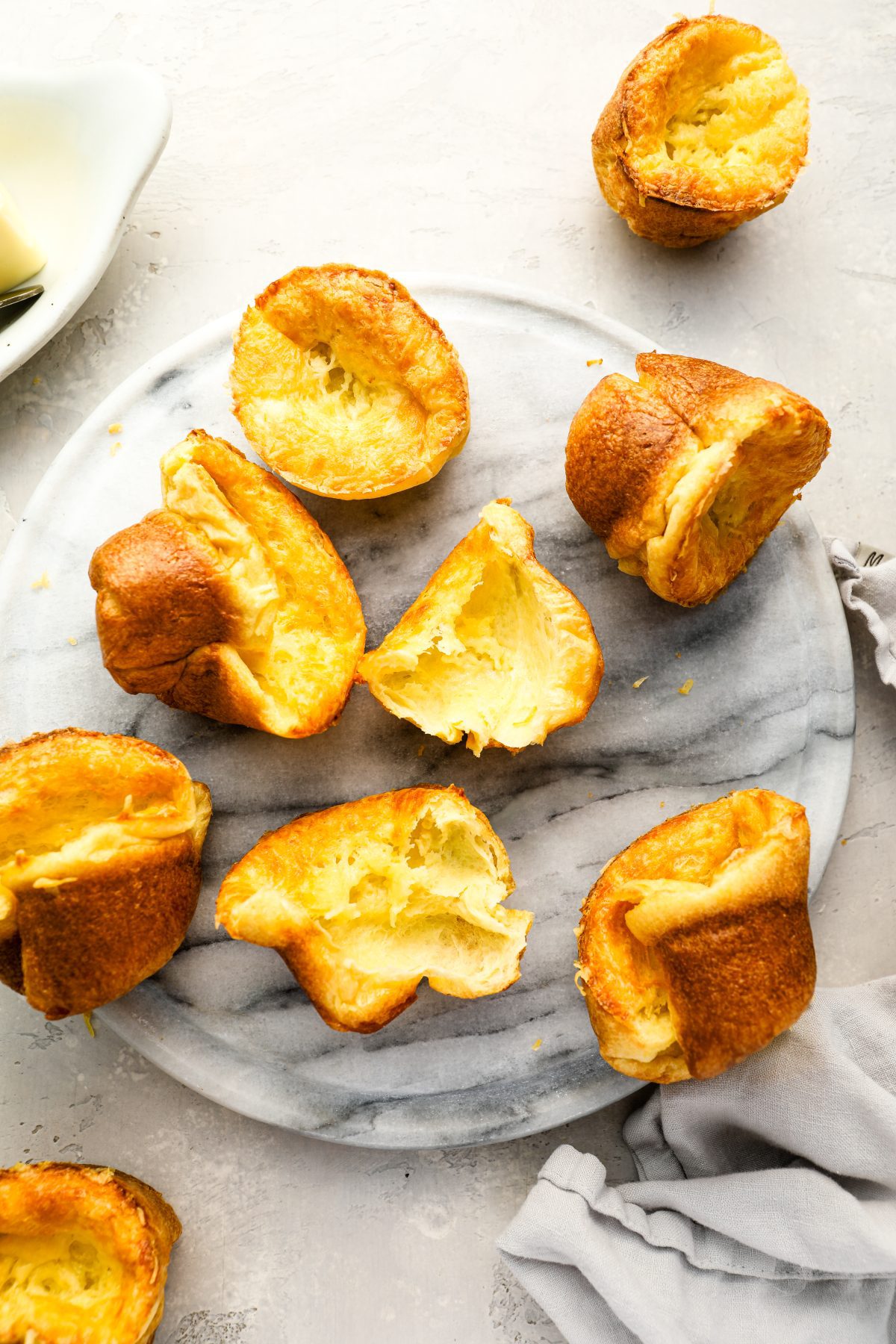 baked popovers scattered on gray marbled serving platter