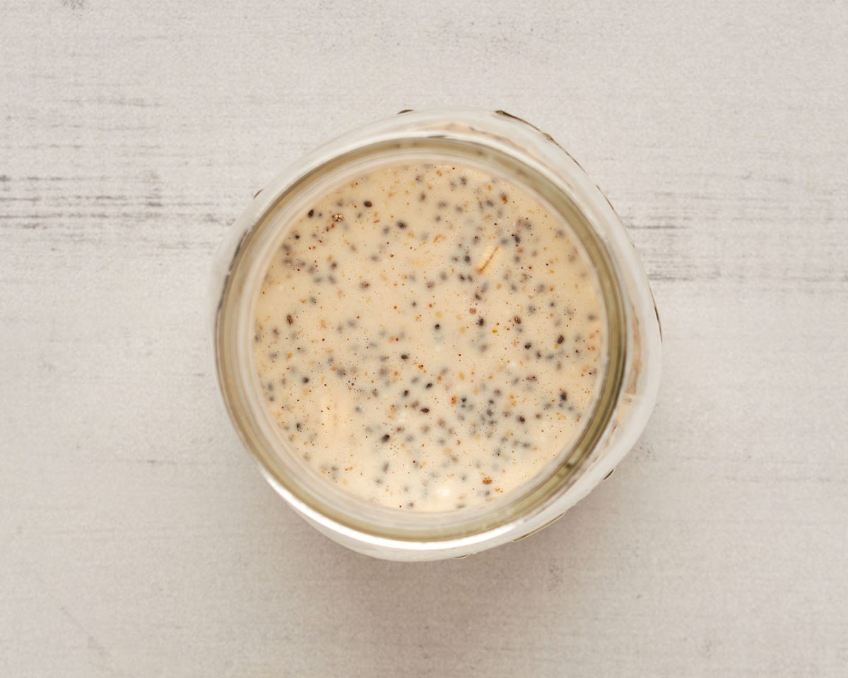 small jar with oats, milk, yogurt, chia seeds, maple syrup, cinnamon, and salt mixed together